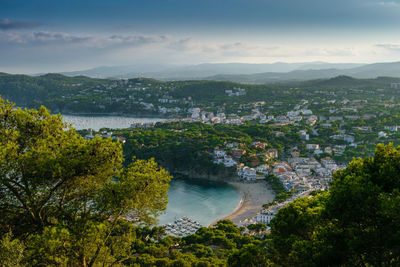 High angle view of river by townscape against sky