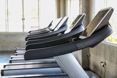 Close-up of empty chairs against window