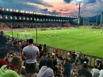 Group of people playing soccer on field