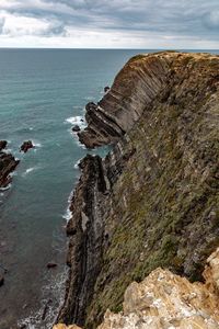 Rock formations by sea against sky