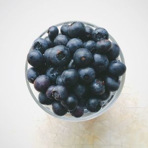 High angle view of blueberries in bowl on table