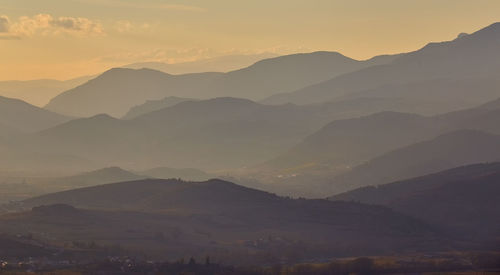 Scenic view of mountains against sky during sunset