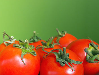 Close-up of red bell peppers on green background