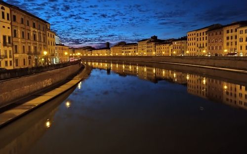 Reflection of illuminated buildings in river at night