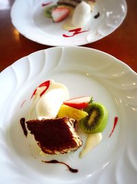 Directly above shot of tiramisu cake and fruits on plate