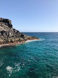 Scenic view of sea against clear blue sky