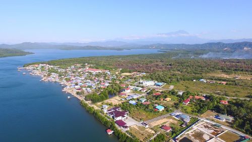 High angle view of buildings by sea against sky