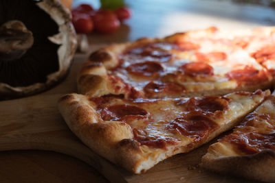 High angle view of pizza on cutting board