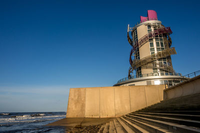 Low angle view of tower against blue sky