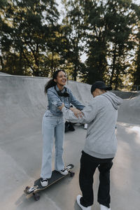 Teenage girl learning how to skate in skate park