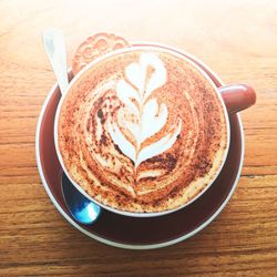 Directly above shot of cappuccino served on table