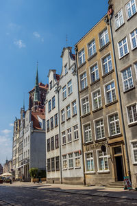 Low angle view of buildings in town against sky