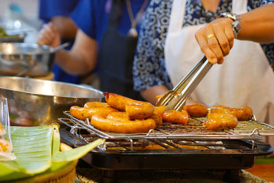 Midsection of man preparing food in kitchen