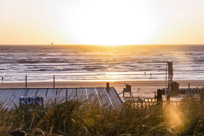 Scenic view of sea against clear sky during sunset