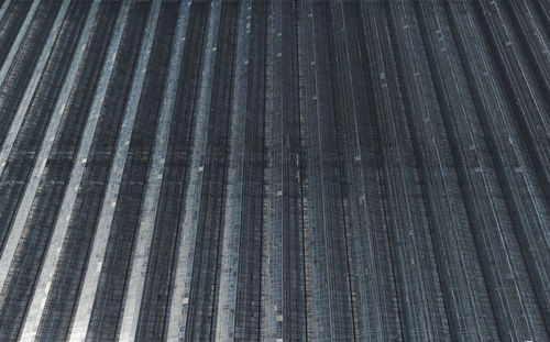 All-season cultivation of crops in giant greenhouse complexes. aerial view of glass greenhouses