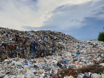 Stack of garbage against sky