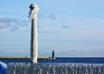 Swan on sea against sky