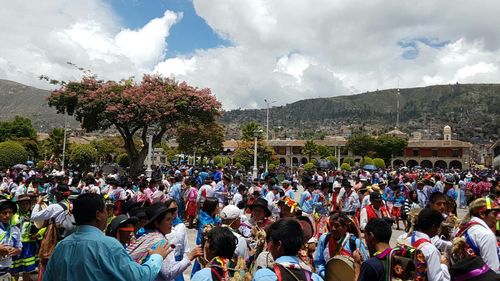 Crowd on mountain against sky