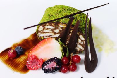 Close-up of dessert with fruits in plate on table