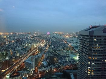 High angle view of city lit up at night