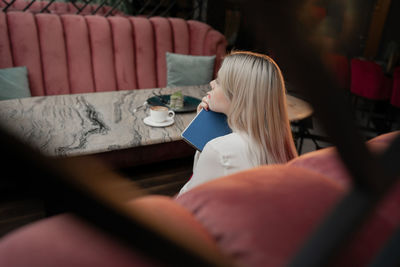 Midsection of woman holding coffee cup