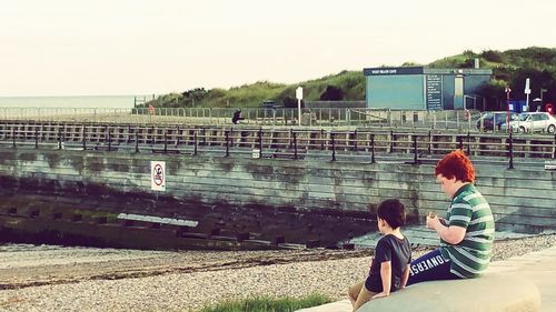 Woman standing by railing