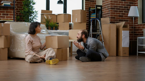 Young woman using laptop while sitting on floor