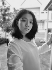 Portrait of young woman standing outdoors