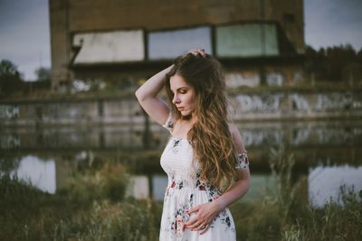 Beautiful young woman standing in water