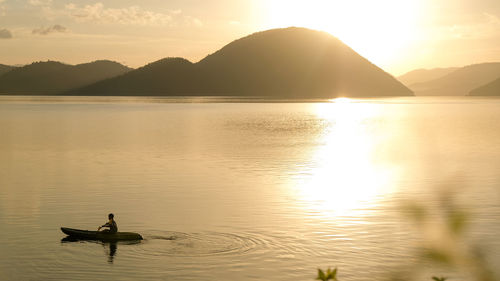 Scenic view of lake against sky during sunset