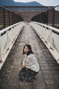 Woman standing on bridge