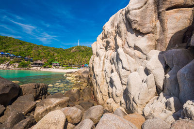 Rock formations by sea against sky