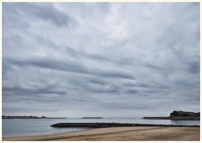 Scenic view of sea against cloudy sky