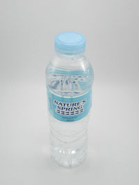 Close-up of glass bottle against white background