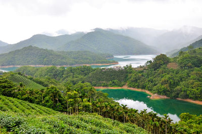 Scenic view of lake and mountains against sky