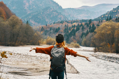 Rear view of man standing by mountain