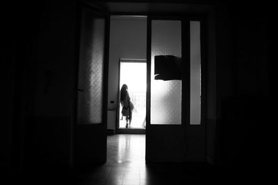 Woman standing by window