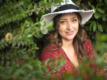 Portrait of young woman wearing hat standing outdoors