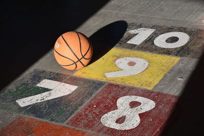 High angle view of basketball ball on numbered court