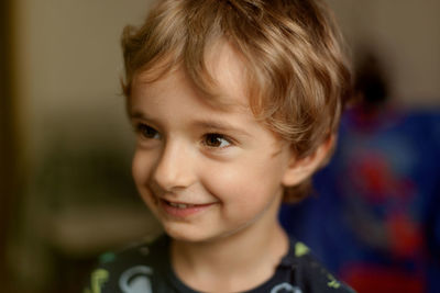 Close-up of cute smiling boy looking away