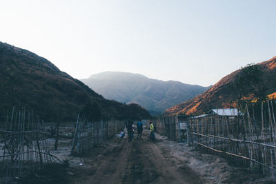 Scenic view of people and village in mountain