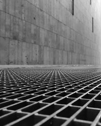 Surface level of tiled floor against brick wall