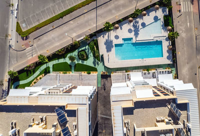 High angle view of buildings by swimming pool in city