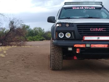 Car parked on road against sky