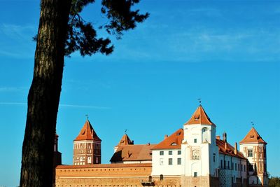 View of buildings against blue sky