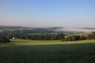 Scenic view of field against clear sky