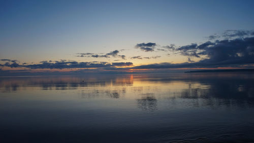Scenic view of lake against sky at sunset
