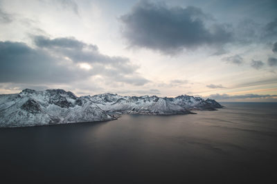  view from mount segla of village of fjordgard rocky mountains on the senja islan in northern norway.