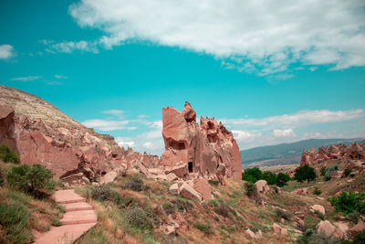 Rock formations on landscape against sky