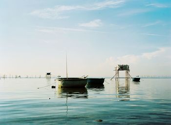 Sailboats in sea against sky